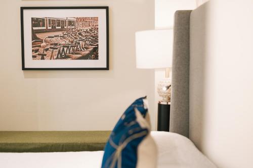 a bedroom with a bed with a picture on the wall at Debambú Atarazanas in Málaga