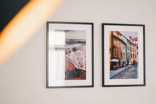three framed pictures hanging on a wall at Debambú Atarazanas in Málaga