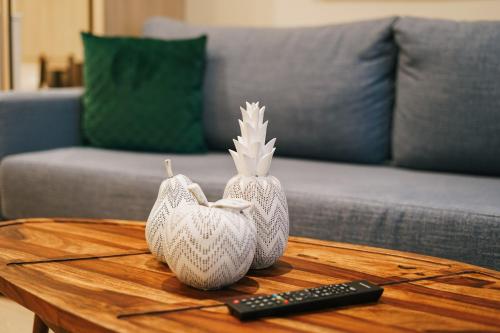 two white vases on a coffee table with a remote control at Debambú Atarazanas in Málaga