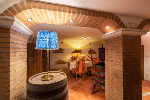 a room with a brick wall and a table with a lamp at Park Hotel Pineta Boutique Hotel in Caorle