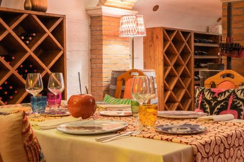 a table with wine glasses and plates on it at Park Hotel Pineta Boutique Hotel in Caorle