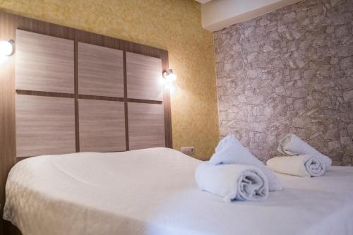 Ένα ή περισσότερα κρεβάτια σε δωμάτιο στο Minos Boutique Hotel