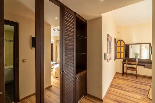 a hallway with a sliding door to a bathroom at Ladiko Suites - Faliraki in Faliraki