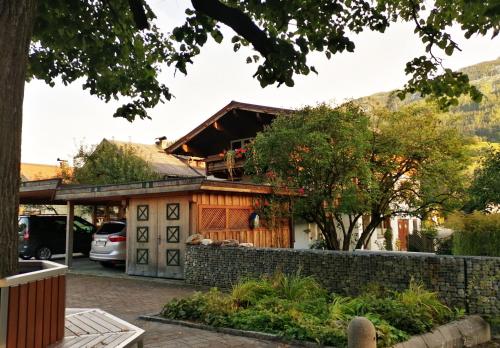 a house with a garage and a fence at Haus Hofer in Bramberg am Wildkogel