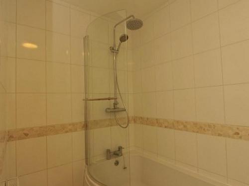 a bathroom with a shower and a bath tub at Gail's Guest House in Barry