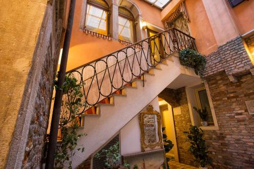
a staircase leading up to a building with a balcony at Locanda Cà Le Vele in Venice
