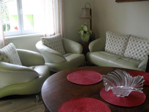 a living room with couches and a table and chairs at Pension Rak in Karlovy Vary