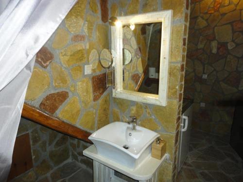 a bathroom with a sink and a mirror at KALAVRITA INN in Kalavrita
