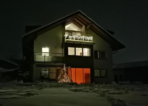 a house with a christmas tree in front of it at Ferienwohnungen Simon - Hauserhof in Oberperfuss