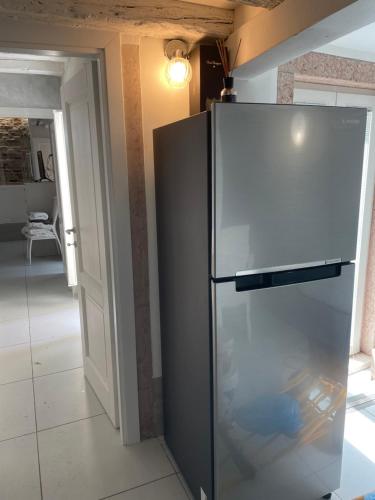 a stainless steel refrigerator in a living room at Blusuite appartamento in Venice