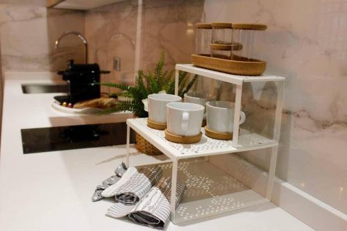 a shelf with cups and mugs on it in a kitchen at Ca Cici Venice Loft Apartment in Venice