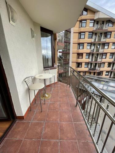 a balcony with tables and chairs on a building at Borovets Holiday Apartments - Different Locations in Borovets in Borovets