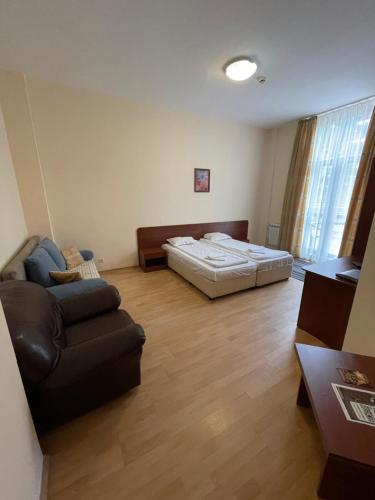 a living room with a bed and a couch at Borovets Holiday Apartments - Different Locations in Borovets in Borovets