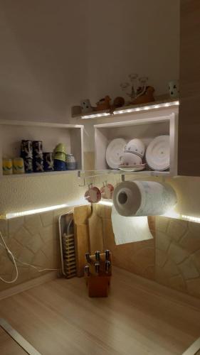 a shelf with a roll of paper towels and plates at Nel Giardino di Carla in Rapallo