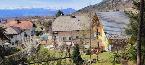a group of houses with mountains in the background at Apartment Murka in Begunje na Gorenjskem