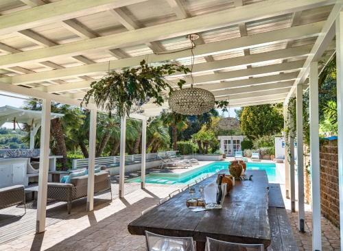 an outdoor patio with a table and a swimming pool at Villa Silvio in Civitanova Alta