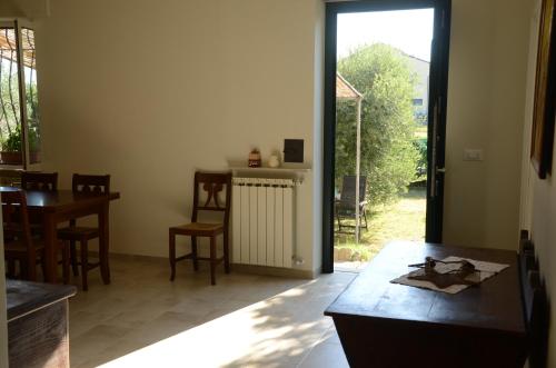 a living room with a table and a dining room at Calicantus bed and breakfast in Albenga