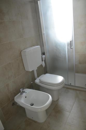 a bathroom with a toilet and a sink and a shower at Calicantus bed and breakfast in Albenga