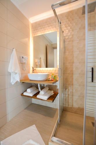 a bathroom with a sink and a shower at Meltemi Studios in Vasiliki