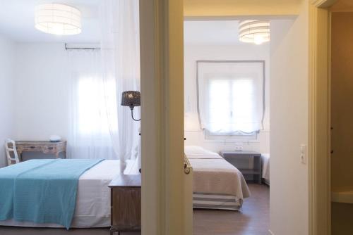 a bedroom with a bed and a window at PyleanBlue villas in Pylos