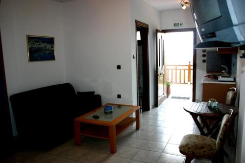 a living room with a couch and a coffee table at Studios Erotokritos in Ammouliani