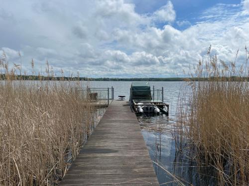 a dock with a boat in the middle of a lake at Wandlitzsee in Wandlitz