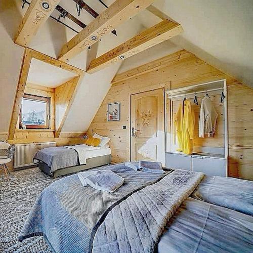 a bedroom with two beds in a attic at Chaty Misiagi in Poronin