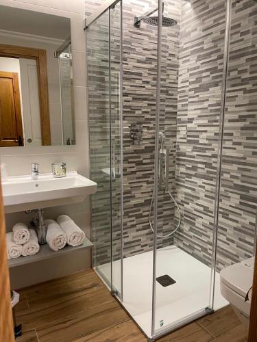 a bathroom with a shower and a sink at Hotel Rural Peña Castil in Sotres