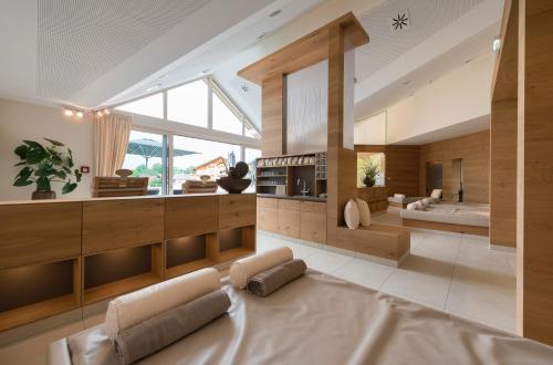 a living room with a large couch and a large window at Hotel Grünauerhof in Wals