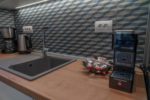 a kitchen counter with a sink and a coffee maker at Tompazi 2 in Kavala