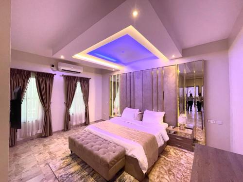 a large bedroom with a large bed and a couch at God's Touch Apartments Signature in Lagos