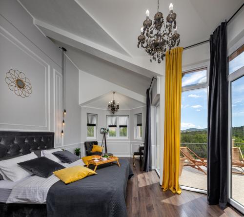 a bedroom with a large bed and a chandelier at Villa Sebenico in Šibenik