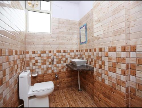 a bathroom with a toilet and a sink at HOTEL SHIV PALACE in Jaipur