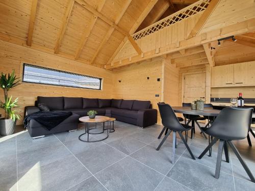 a living room with a couch and a table at Chalet aan de Oosterschelde met Airconditioning! in Sint Annaland