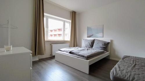Кровать или кровати в номере Moderne City Apartments im Stadtzentrum