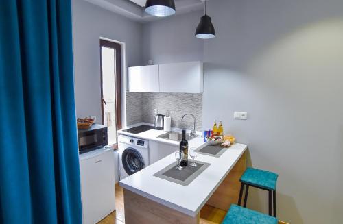 a kitchen with a sink and a washing machine at Our Apartment in Kutaisi