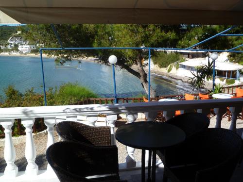 a balcony with chairs and a view of a beach at Liberty II in Agia Marina Aegina