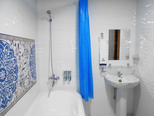 a bathroom with a tub and a sink and a shower at Colibri Traditional Guest house in Samarkand