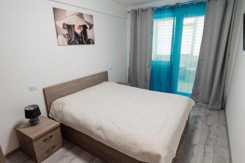 a small bedroom with a bed and a window at Home sweet home 2 in Bacău