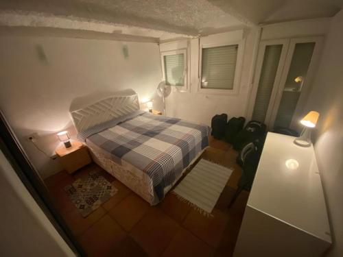 a small bedroom with a bed and a window at Villa Abdul in Estepona
