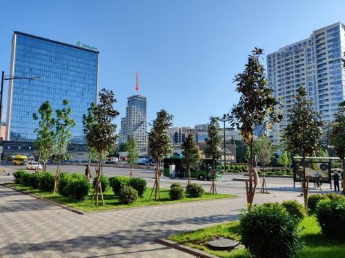 a park with trees in the middle of a city at Tbilisi App 2 in Tbilisi City