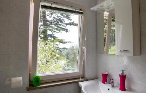 a bathroom with a sink and a window at Oleander in Portorož