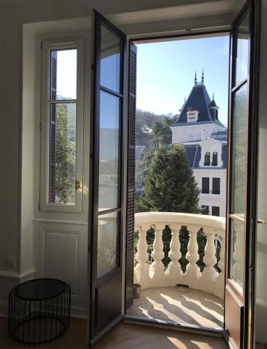 a door to a balcony with a view of a building at Studio 329 in Aix-les-Bains