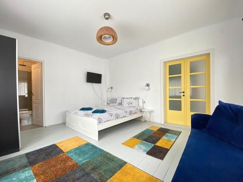 Habitación blanca con cama y sofá en Casa Ghioceilor en Vatra Dornei