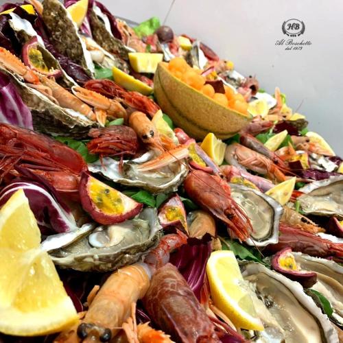 a plate of seafood and vegetables with lemon slices at Hotel Ristorante Al Boschetto in Cassino