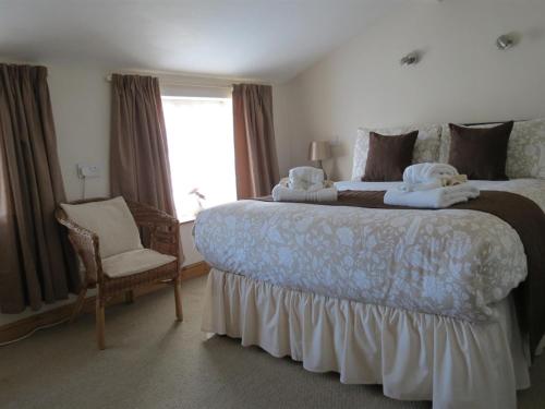 a bedroom with a large bed with towels on it at Crab pot cottage in Flamborough