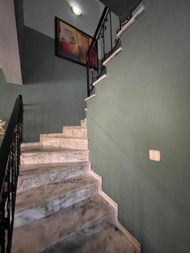 a set of stairs with a television on the wall at Villa Kalliopi in Keramotí
