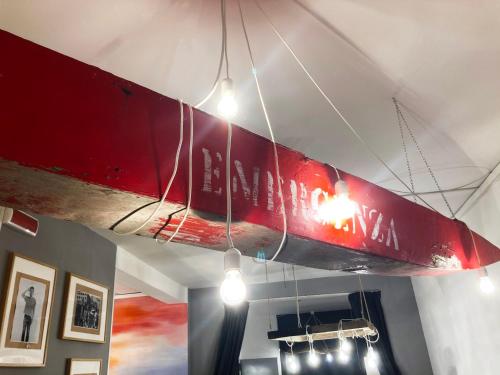 a red surfboard hanging from the ceiling of a room at Hotel Nizza Creative Hotel in Rimini