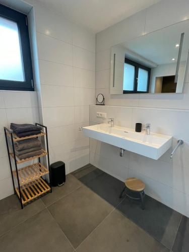 a bathroom with a sink and a mirror at Luxury Chalet Mauthner Alm in Kötschach