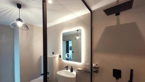 a bathroom with a sink and a mirror at Katsoleil in La Bâtie-Neuve